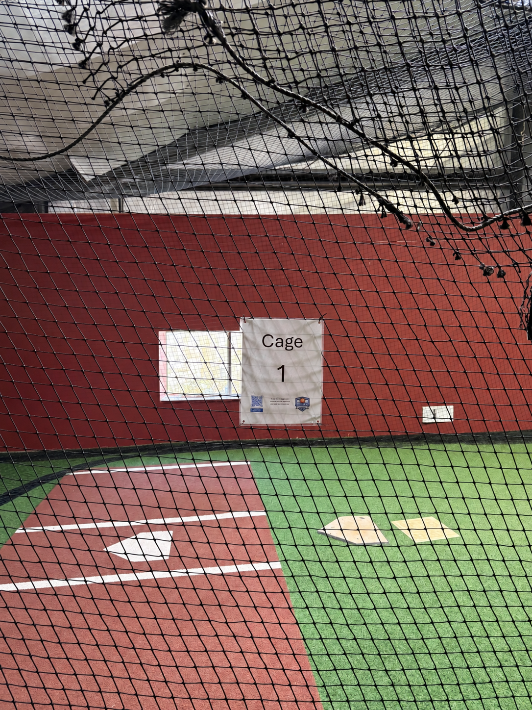 Cage 1 batting area with netting, turf, and a home plate hitting mat