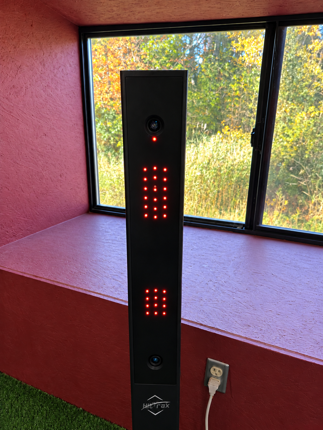 HitTrax sensor tower with all existing indicator lights illustrated in red