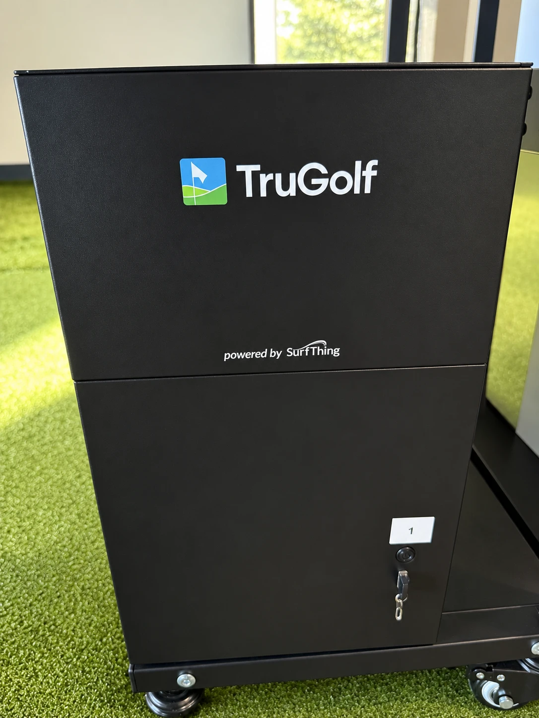 TruGolf computer labeled 1, with power button below the label